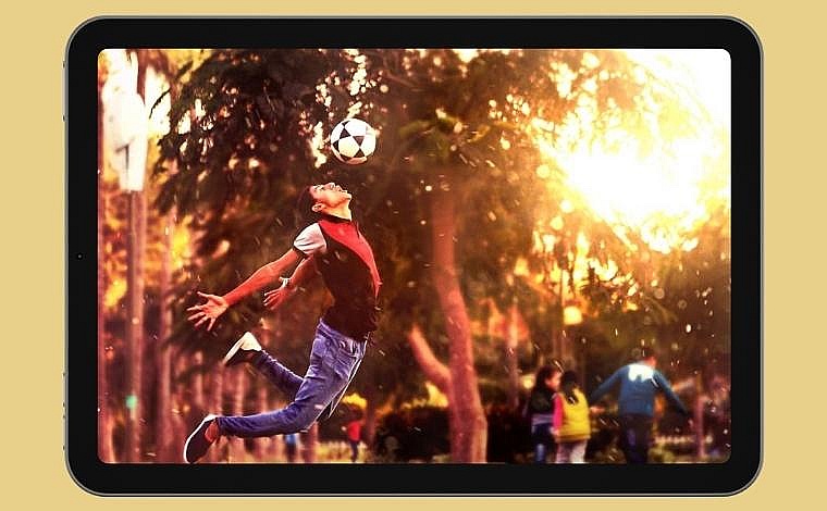 A young man jumps up for a header